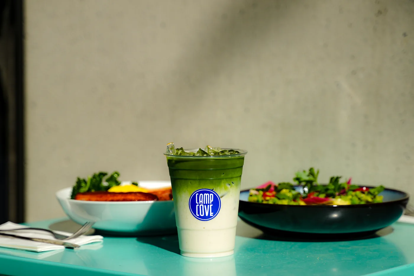Matcha and breakfast on a Camp Cove café table